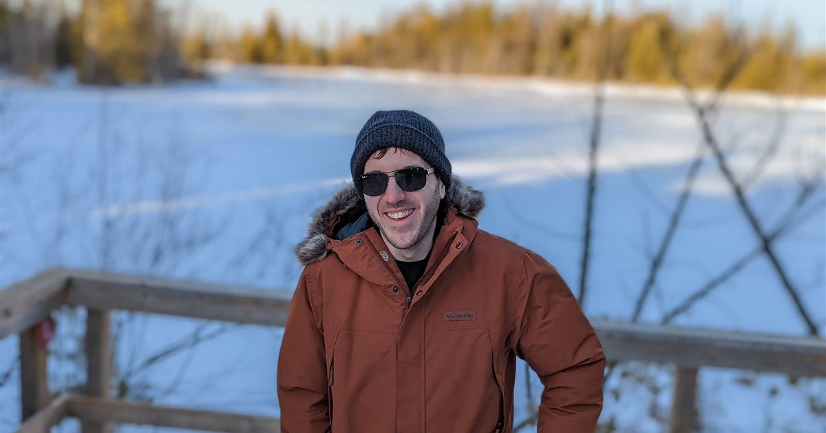 Alessandro Filazzola beside a frozen lake on a sunny winter day